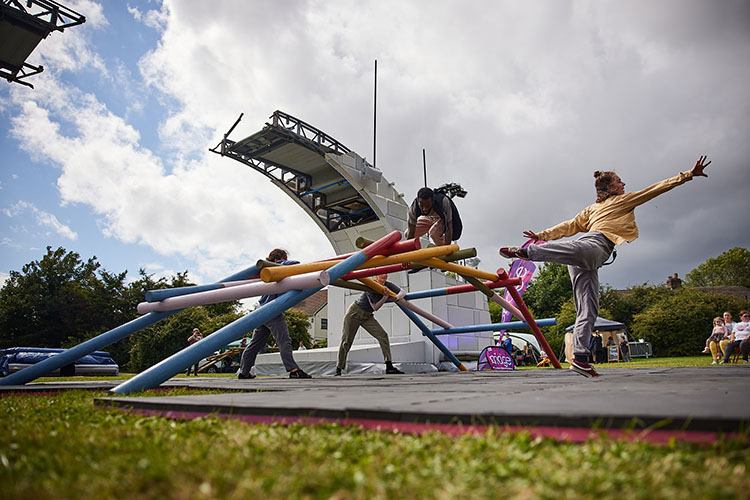 Dancers perform on a self-supporting bridge underneath the main broken bridge