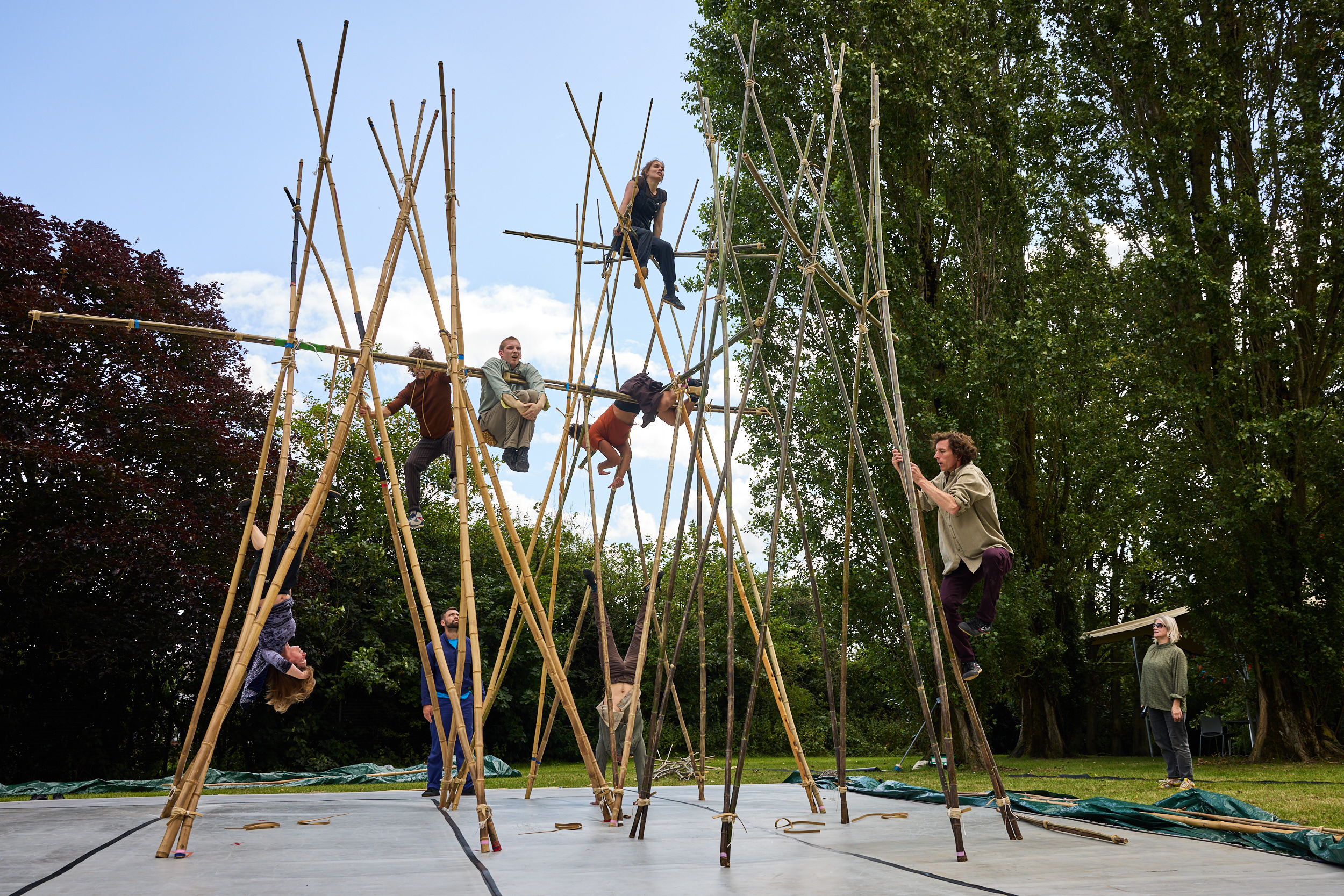 Circus artists climb over a 10m tall structure made of bamboo