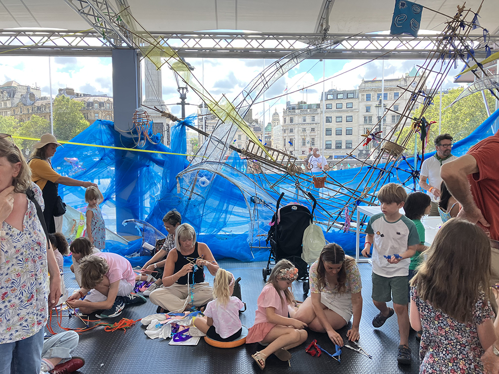children and families crafting with bamboo sticks