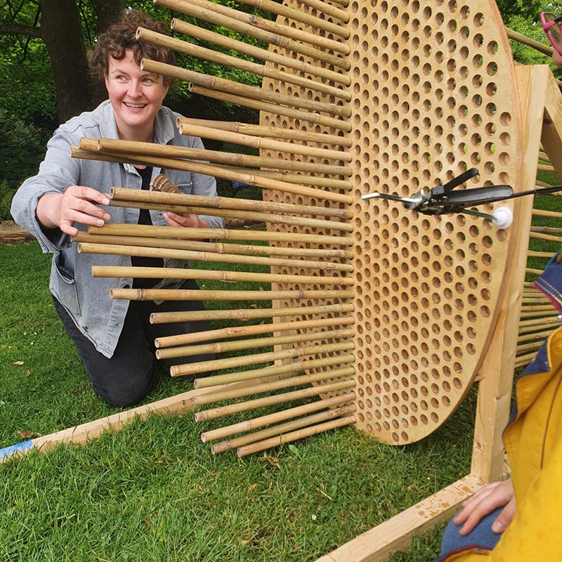 Bamboo is turned into a structure with horizontal pieces.